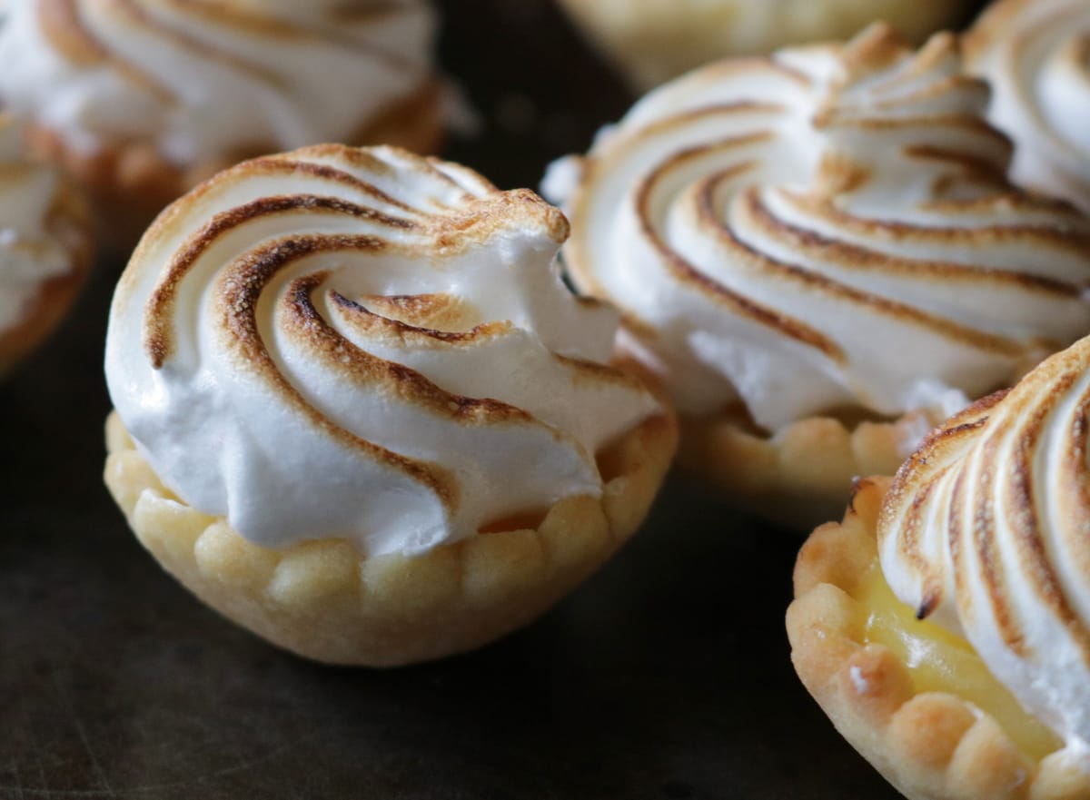 Small lemon tarts with torched meringue, close-up